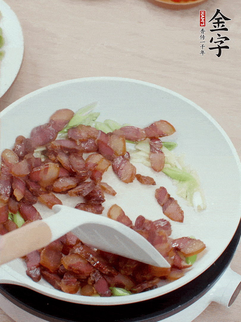 鍋中少許油，姜、蒜白爆香，下臘肉煸出油脂。
